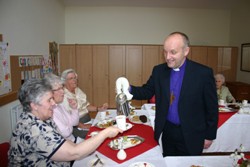 Bishop Alan serves the tea from a silver teapot!